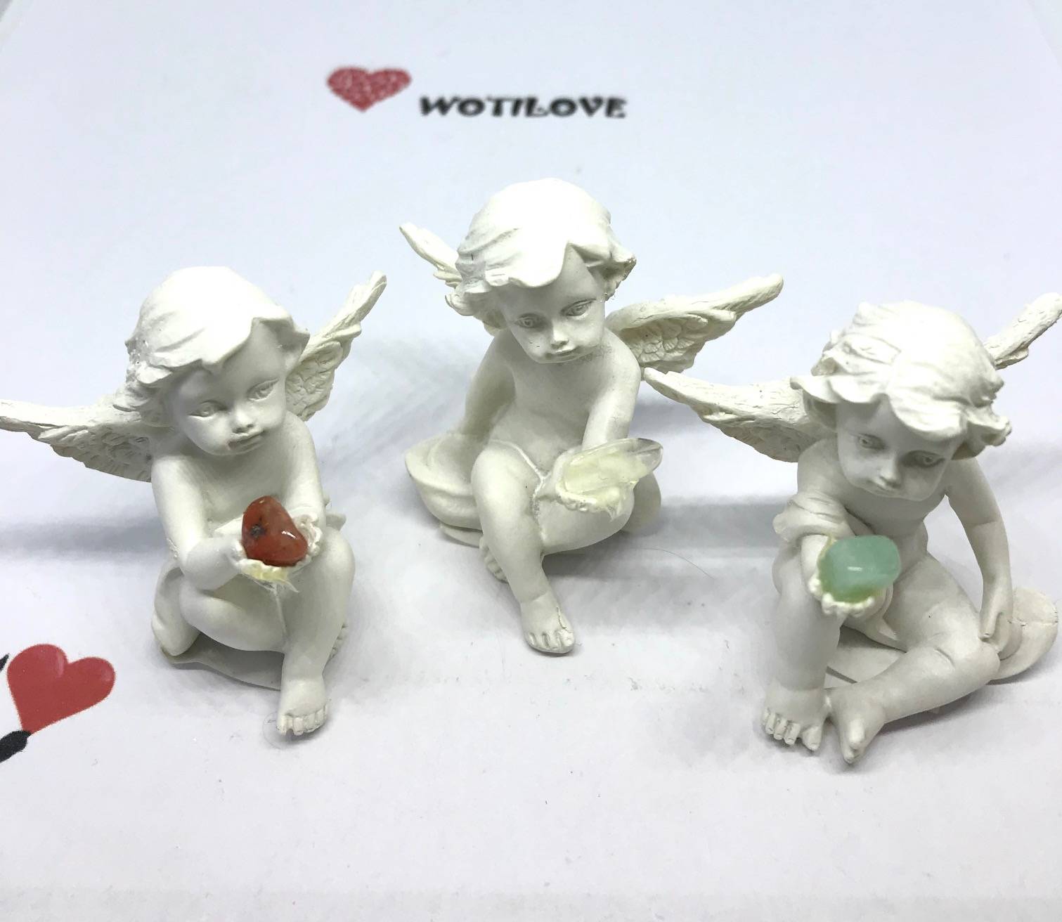 Mini Cherub sitting holding gem